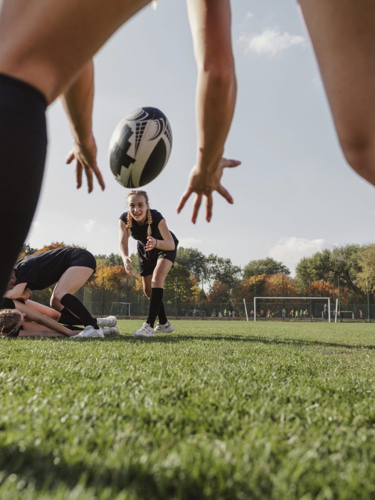 back-view-women-hands-trying-to-catch-rugby-ball